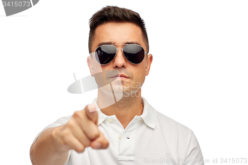 Image of face of man in polo t-shirt and sunglasses