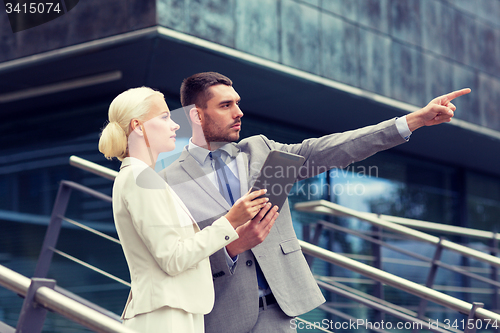 Image of serious businessmen with tablet pc outdoors