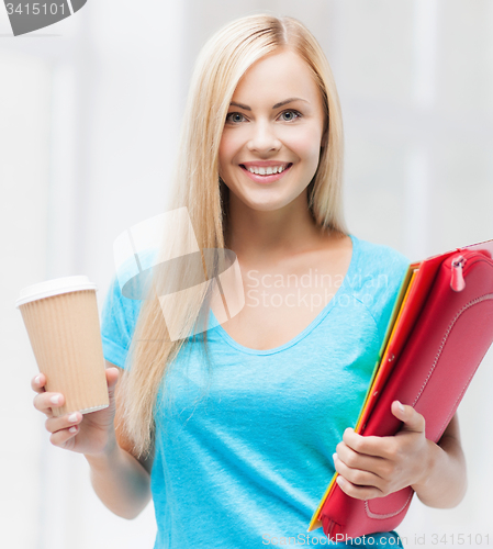 Image of smiling student with folders