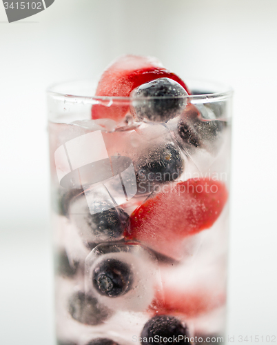 Image of close up of fruit water with ice cubes in glass