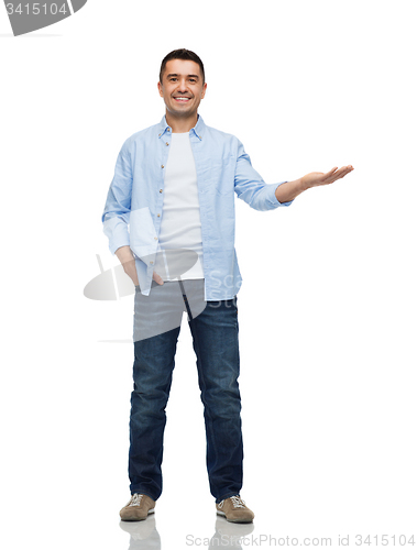 Image of smiling man showing something on empty palm