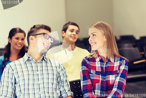 Image of group of smiling students in lecture hall