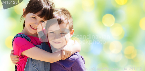 Image of two happy kids hugging over green lights