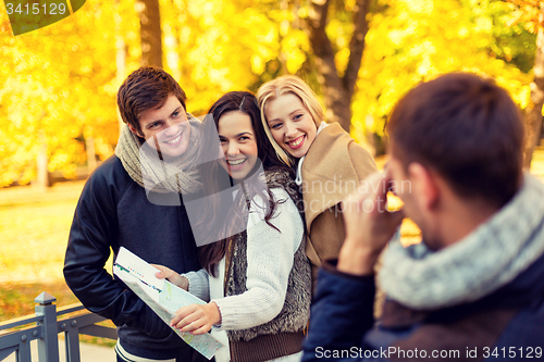 Image of group of friends with map outdoors