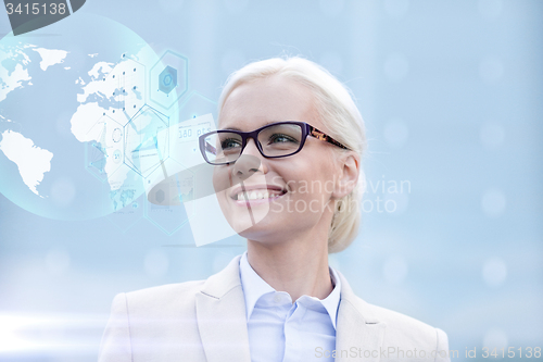 Image of young smiling businesswoman in eyeglasses outdoors