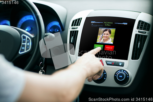 Image of male hand receiving video call on car panel screen