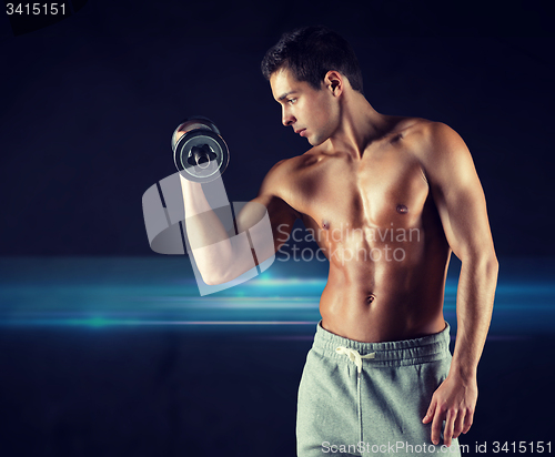 Image of young man with dumbbell flexing biceps