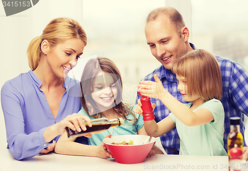 Image of happy family with two kids eating at home