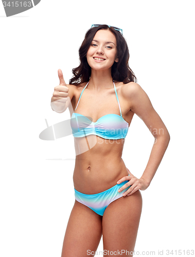 Image of happy woman in swimsuit showing thumbs up