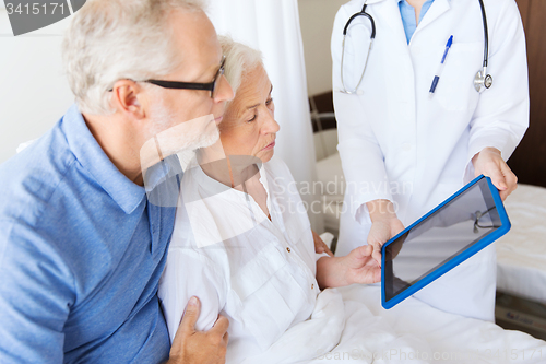 Image of senior woman and doctor with tablet pc at hospital