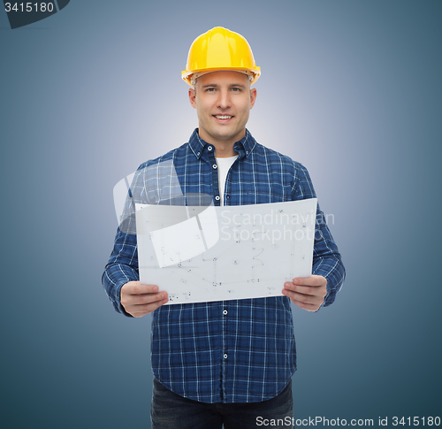 Image of smiling male builder in helmet with blueprint