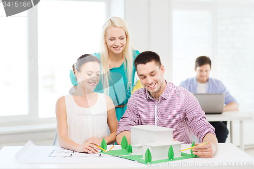 Image of smiling architects working in office