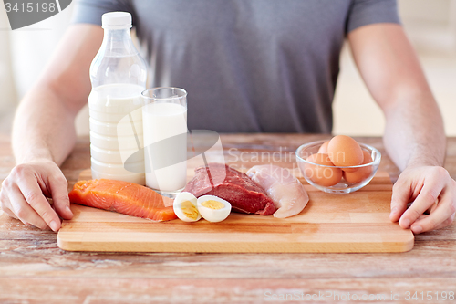 Image of close up of male hands with food rich in protein