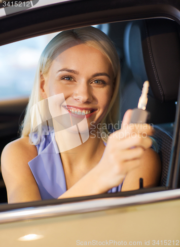 Image of happy woman getting car key in auto show or salon