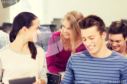 Image of group of smiling students with tablet pc