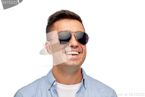 Image of face of smiling man in shirt and sunglasses