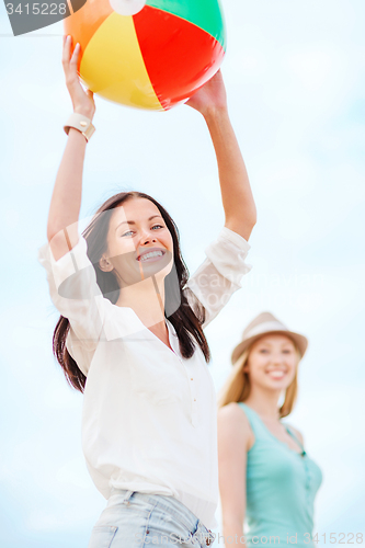 Image of girls playing ball on the beach