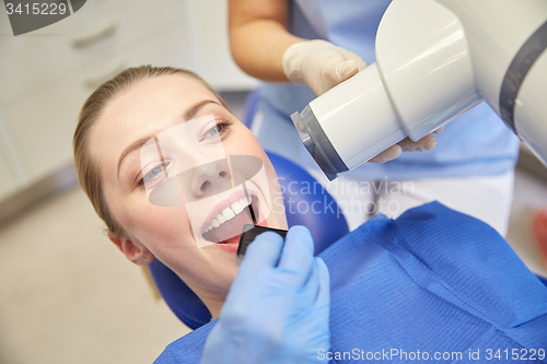 Image of female patient face with x-ray machine and shield