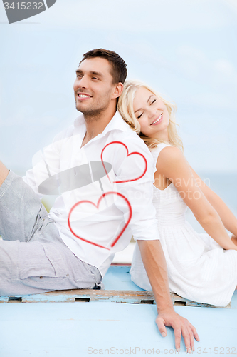 Image of couple sitting on boat at sea side