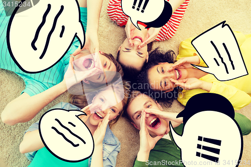 Image of smiling people lying down on floor and screaming