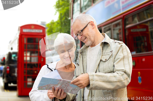 Image of senior couple with map on london in city street