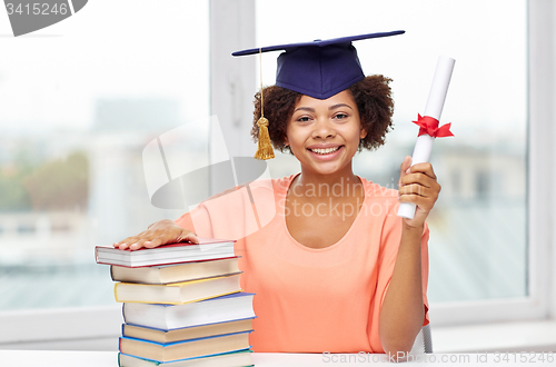 Image of happy african bachelor girl with books and diploma
