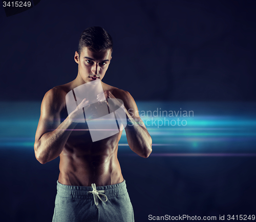 Image of young man in fighting or boxing position