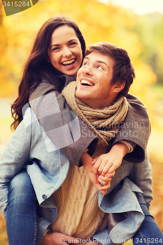 Image of smiling couple hugging in autumn park