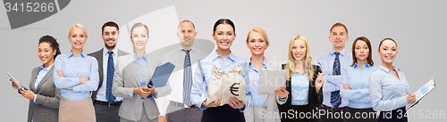 Image of group of happy businesspeople with money bags