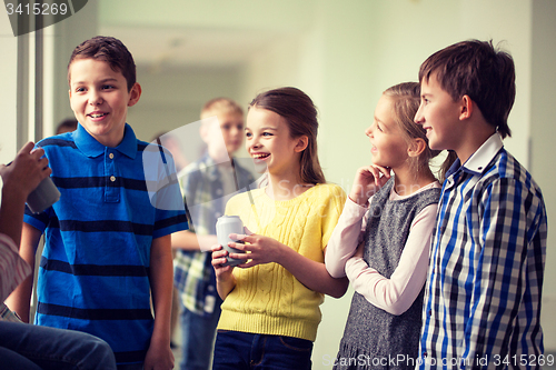 Image of group of school kids with soda cans in corridor