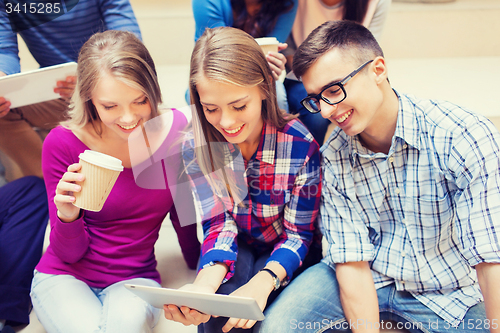 Image of group of students with tablet pc and coffee cup