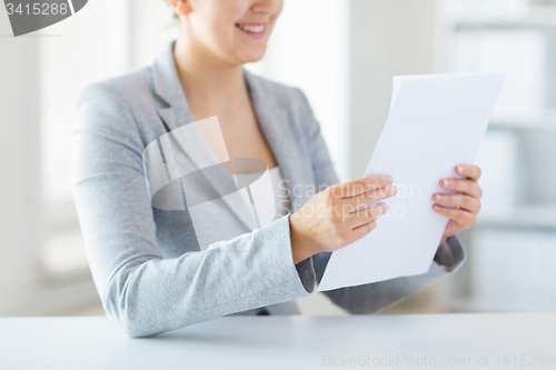 Image of close up of woman reading papers or tax report