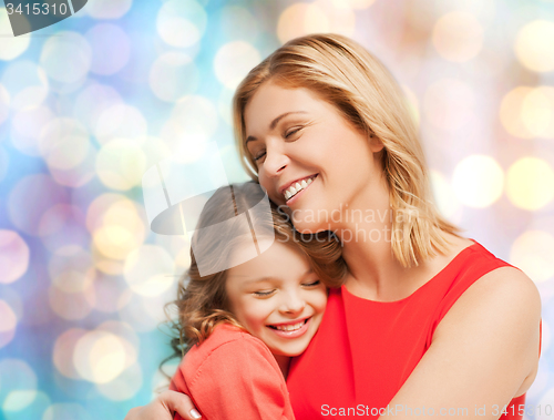 Image of happy mother and daughter hugging