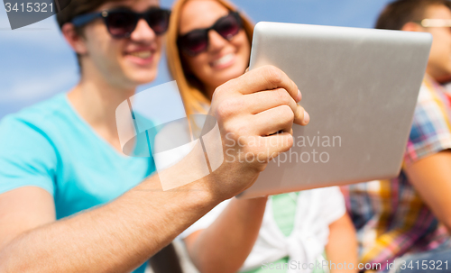 Image of happy couple with tablet pc taking selfie outdoors