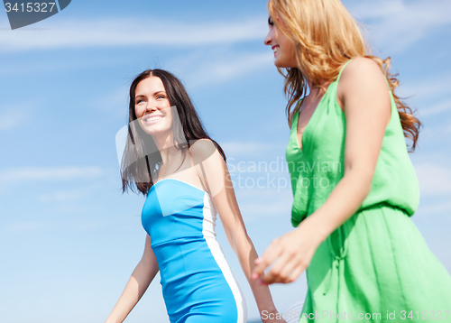 Image of girls walking on the beach