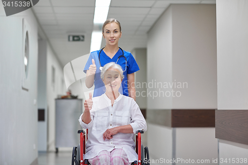 Image of nurse with senior woman in wheelchair at hospital