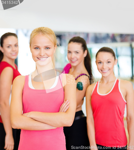 Image of woman standing in front of the group in gym