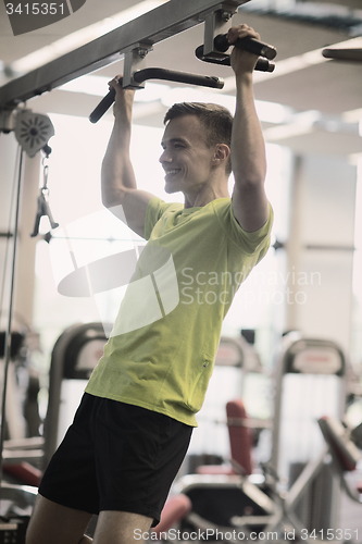 Image of smiling man exercising in gym