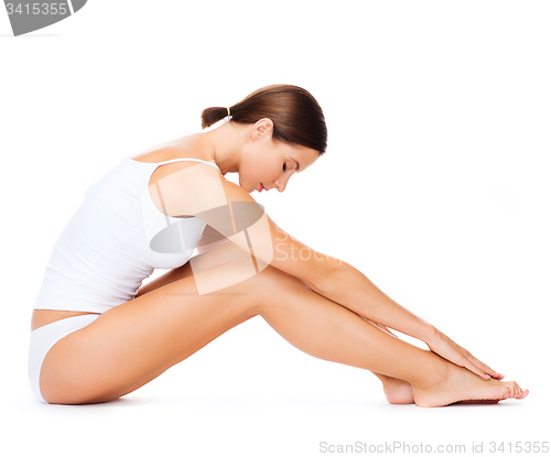 Image of woman in cotton underwear doing exercises