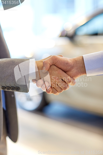 Image of close up of male handshake in auto show or salon