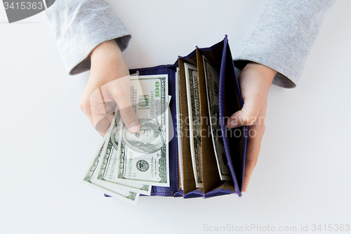 Image of close up of woman hands with wallet and money