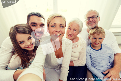 Image of happy family making selfie at home