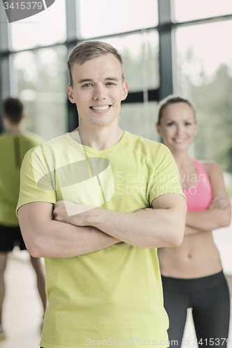 Image of smiling man and woman in gym