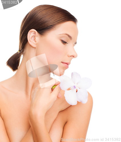 Image of relaxed woman with orchid flower