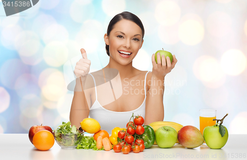 Image of happy woman with healthy food showing thumbs up