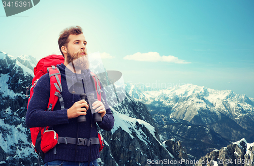 Image of man with backpack and binocular outdoors