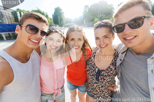 Image of smiling friends taking selfie