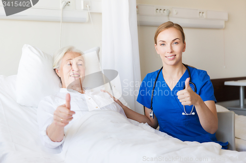 Image of nurse and senior woman showing thumbs up at clinic