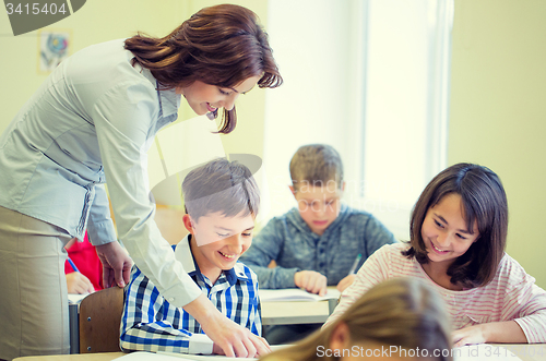 Image of group of school kids writing test in classroom