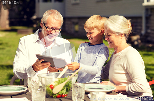 Image of happy family with tablet pc outdoors